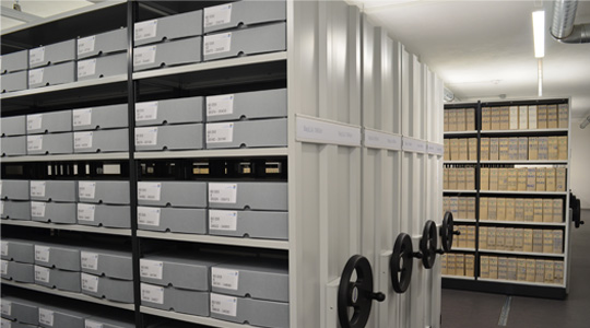 Einblick in das Archiv des BayLLZ, mit Rollregalen und Kartons